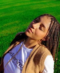 a woman wearing a tan vest