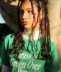 a woman wearing a green t - shirt