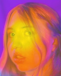 a photo of a girl with a rainbow colored background