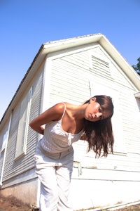 a woman standing in front of a house