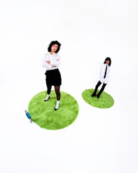 two people standing next to each other on a green field