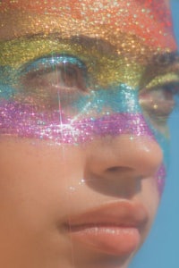 a girl with colorful glitter on her face