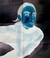 a photo of a woman with blue skin on a black background