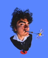 a man with a flower in his mouth