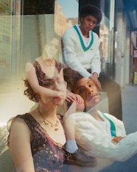 a group of people posing in front of a window