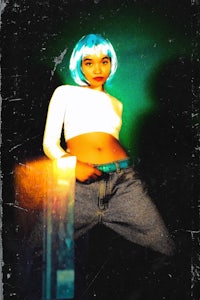 a woman in jeans and a blue wig