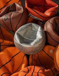 a group of basketball balls in a pile