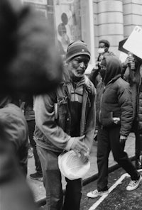 a black and white photo of a man holding a frisbee