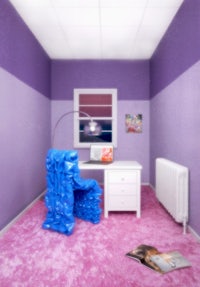 a room with purple walls and a blue chair