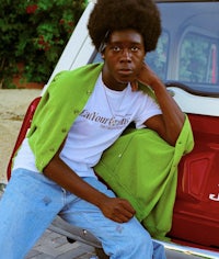 a man sitting in the back of a truck